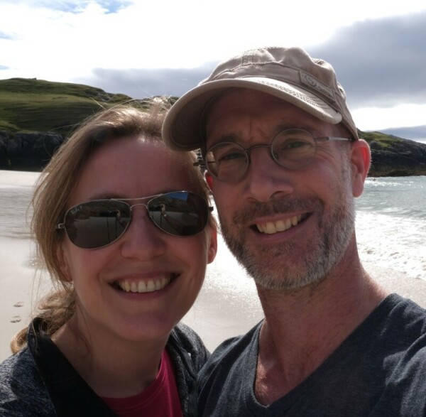 My wife and me, smiling on a cold beach